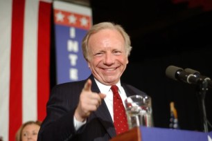 Joe Lieberman, in a suit, pointing at the camera