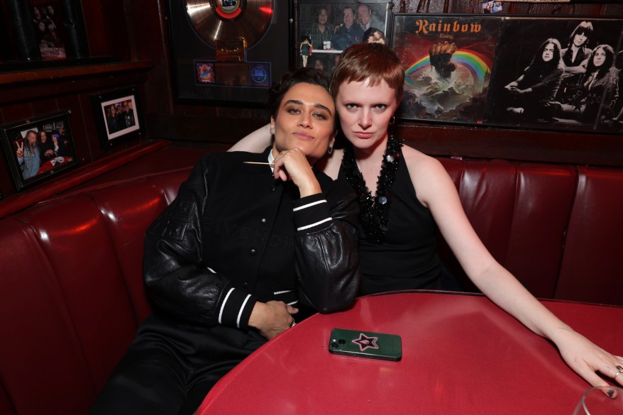 Katy O'Brian and Rose Glass sitting at a table at the "Love Lies Bleeding" after party in Beverly Hills, California.