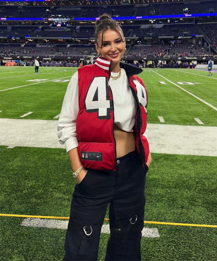 Kristin Juszczyk rocks one of her custom puffer vests at a 49ers game. 