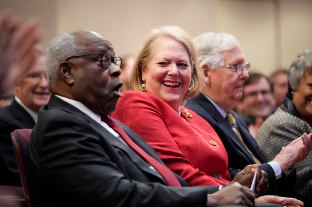 Associate Supreme Court Justice Clarence Thomas sits with his wife and conservative activist Virginia Thomas while he waits to speak at the Heritage Foundation on October 21, 2021 in Washington, DC.