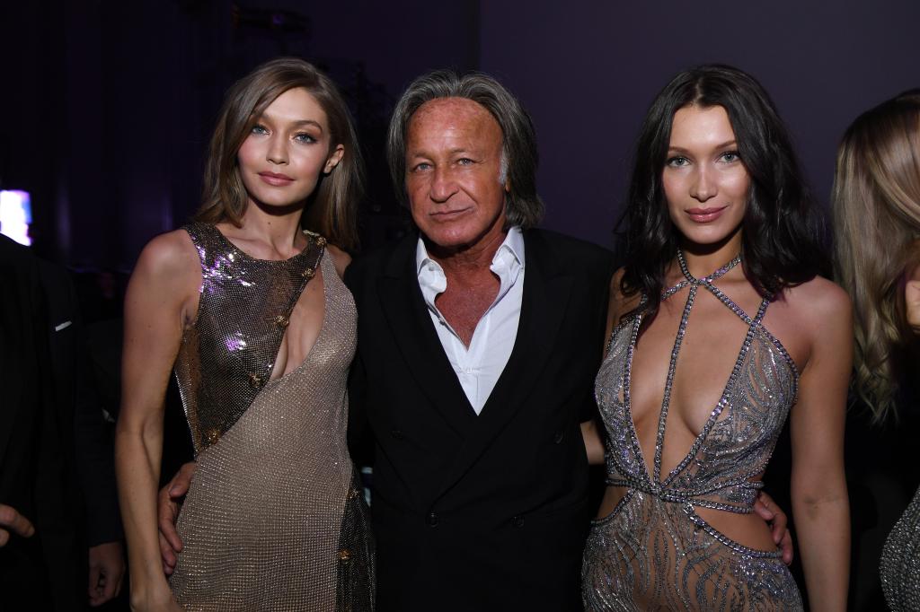 Gigi, Mohamed, and Bella Hadid posing together for a photo at the Victoria's Secret Fashion Show after party in Paris.
