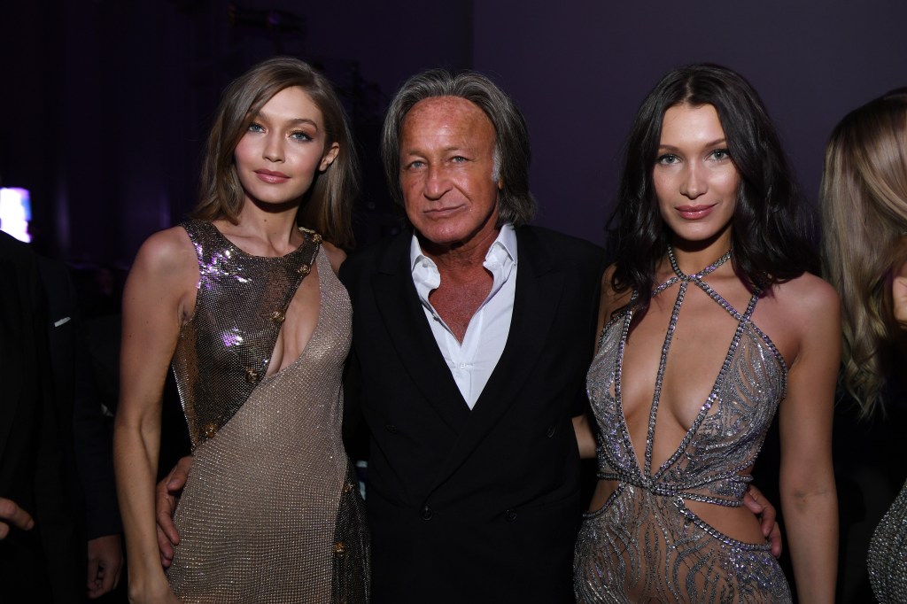 Gigi, Mohamed, and Bella Hadid posing together for a photo at the Victoria's Secret Fashion Show after party in Paris.