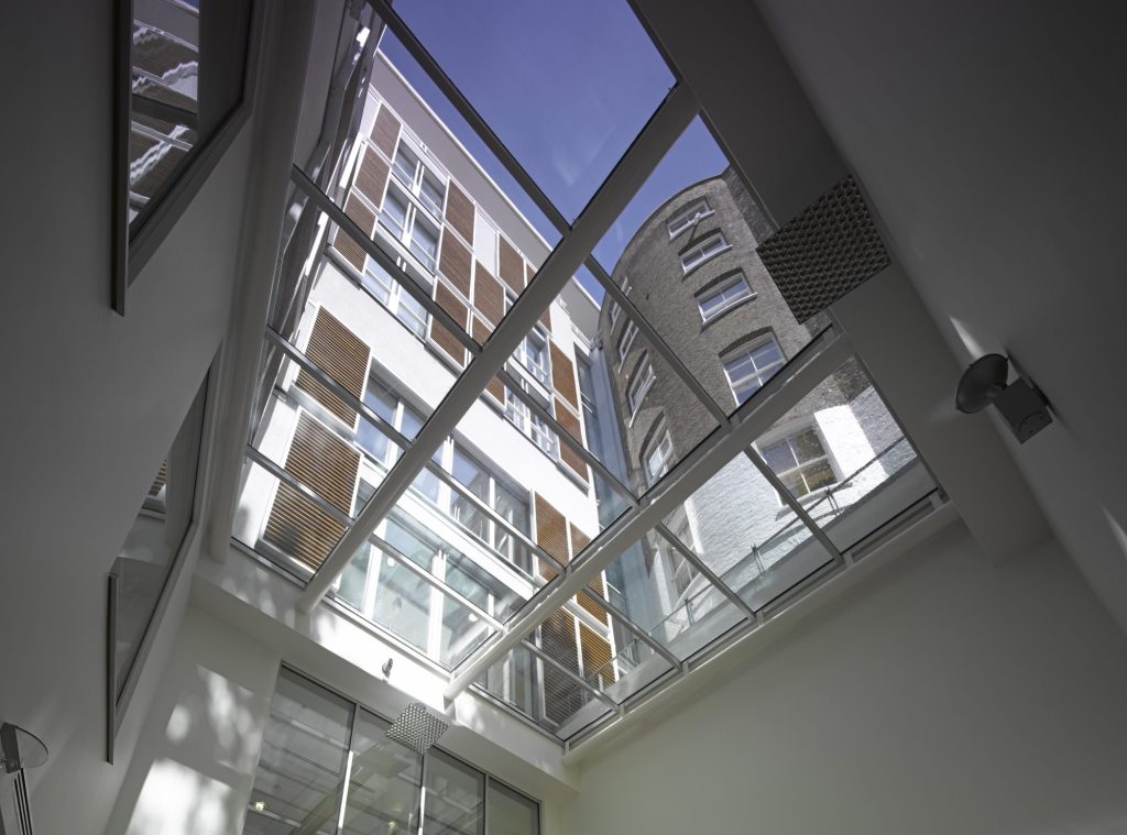 The interior of The London Clinic viewed from below through a glass roof.