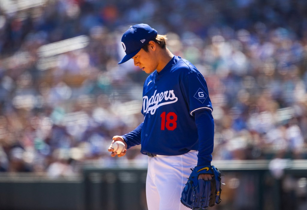 Dodgers pitcher Yoshinobu Yamamoto reacts against the Seattle Mariners