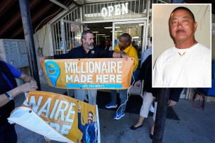 Lottery officials put up banners outside the entrance at the Midway Market & Liquor store, Thursday, Oct. 12, 2023, in Frazier Park, Calif., where a $1.765 billion winning Powerball ticket was sold. (AP Photo/Marcio Jose Sanchez)