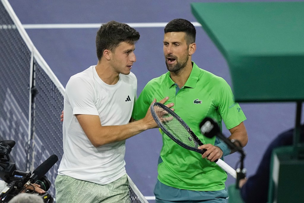 Novak Djokovic (r.) talks with Luca Nardi (l.) after Nardi's win over Djokovic at Indian Wells on March 11, 2024.