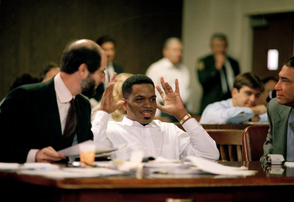 Luther Campbell, leader of hip hop group of 2 Live Crew, right, gestures with his fingers in his ears on the opening day of the obscenity trial of three members of his rap group, Oct. 17, 1990.