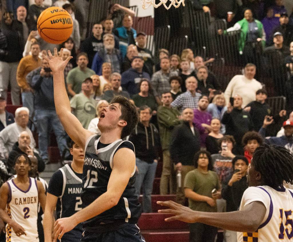 Manasquan's Griffin Linstra attempts game-winning shot at buzzer, referees rule too late. No visible basketball player or celebrity faces.