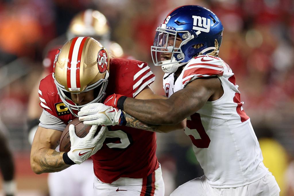 George Kittle #85 of the San Francisco 49ers makes a catch against Xavier McKinney #29 of the New York Giants during the third quarter in the game at Levi's Stadium on September 21, 2023 in Santa Clara, California. 