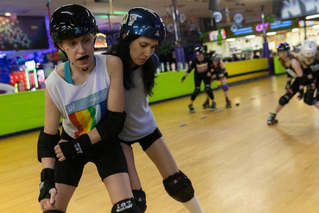 Two members of the Long Island Roller Rebels collide with each other during their practice at United Skates of America on March 19. 2024.