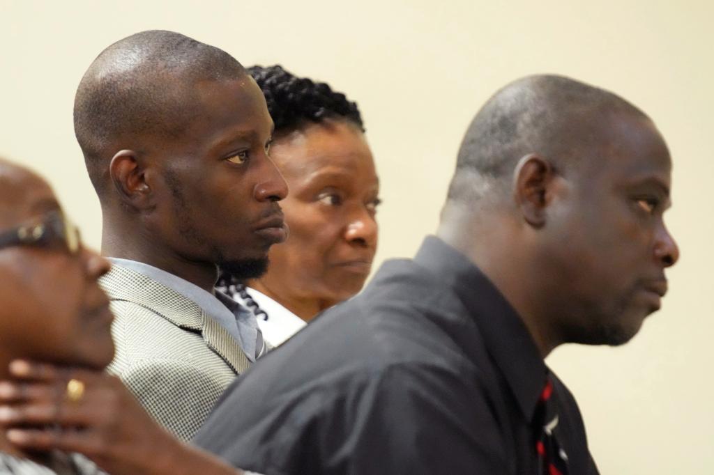 Michael Corey Jenkins, center, and Eddie Terrell Parker, right, listen as one of six former Mississippi law officers pleads guilty to state charges on Aug. 14, 2023.