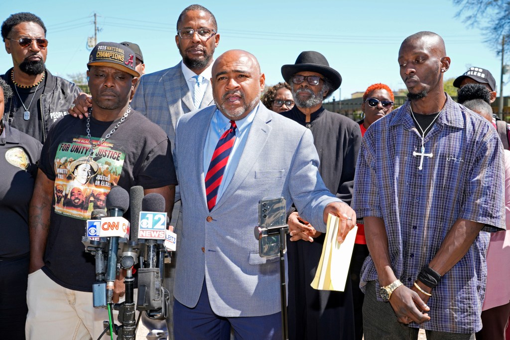 Michael Corey Jenkins, right, and Eddie Terrell Parker, left, stand with their local attorney Trent Walker, as he calls on a federal judge at a news conference Monday, March 18, 2024.