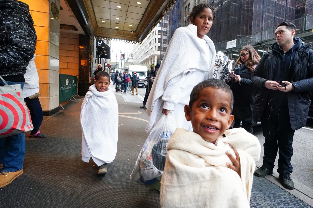 Migrants outside the Roosevelt Hotel shelter