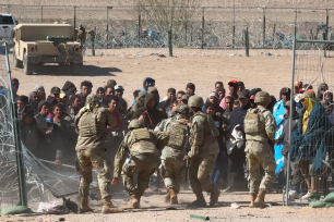 The Post witnessed around 600 migrants massed at the international border, whom Texas National Guard troops were attempting to push back in small groups.