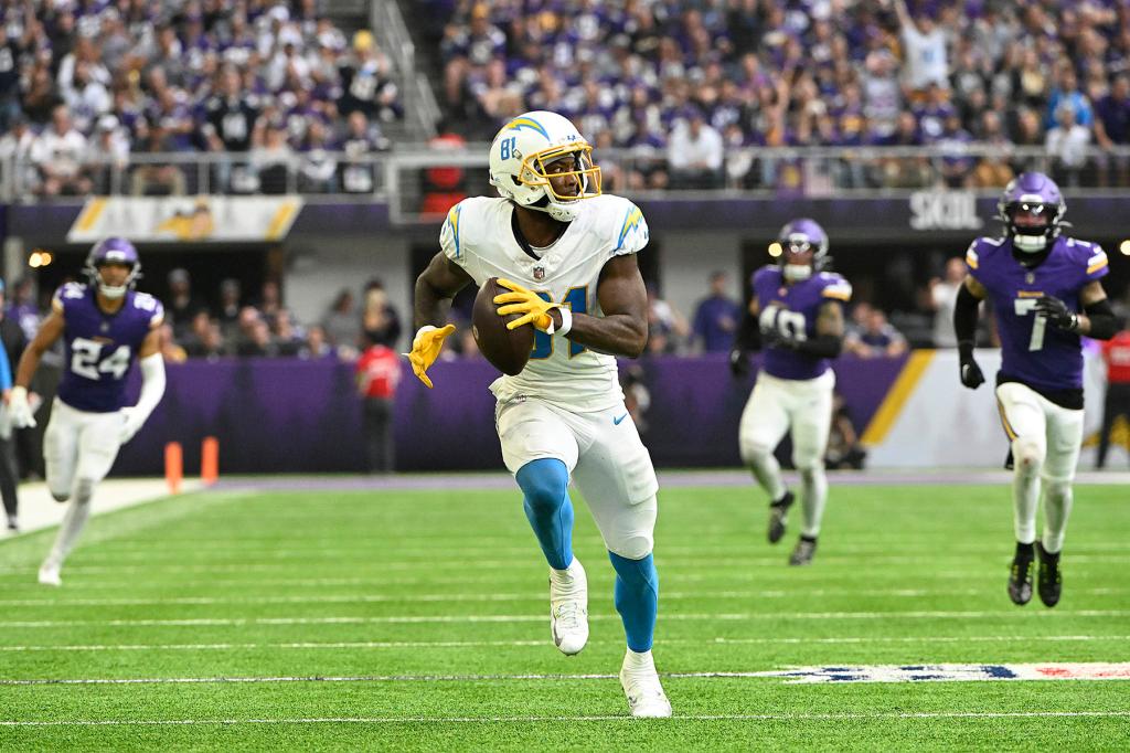 Mike Williams #81 of the Los Angeles Chargers runs for touchdown after a catch during the third quarter against the Minnesota Vikings at U.S. Bank Stadium on September 24, 2023 in Minneapolis, Minnesota. 