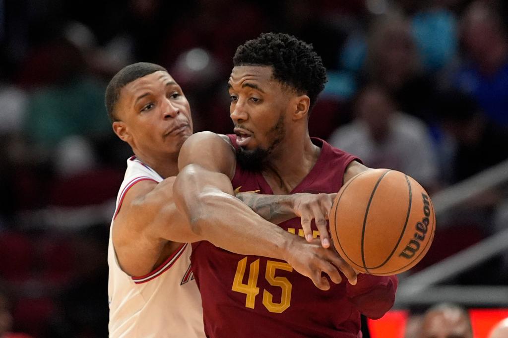 Houston Rockets' Jabari Smith Jr., left, knocks the ball away from Cleveland Cavaliers' Donovan Mitchell (45) during the second half of an NBA basketball game Saturday, March 16, 2024, in Houston. The Rockets won 117-103. 