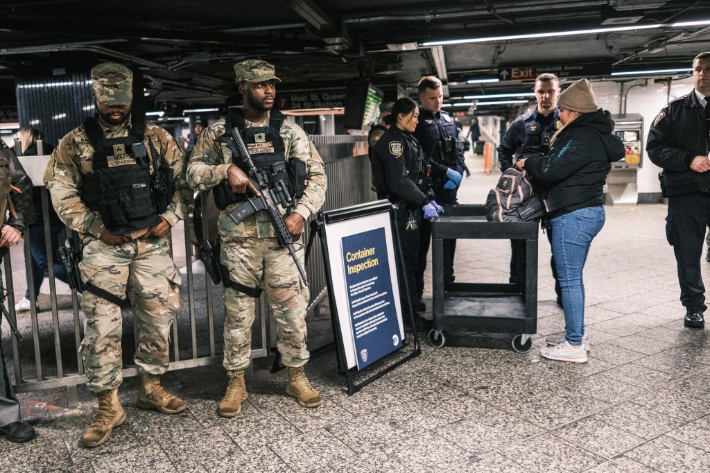 MTA Police and members of the National Guard conduct a random bag check at the entrance to the 7 train at Grand Central Station in Manhattan