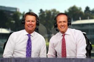 Paul Azinger and Dan Hicks wearing headphones in a golf booth.
