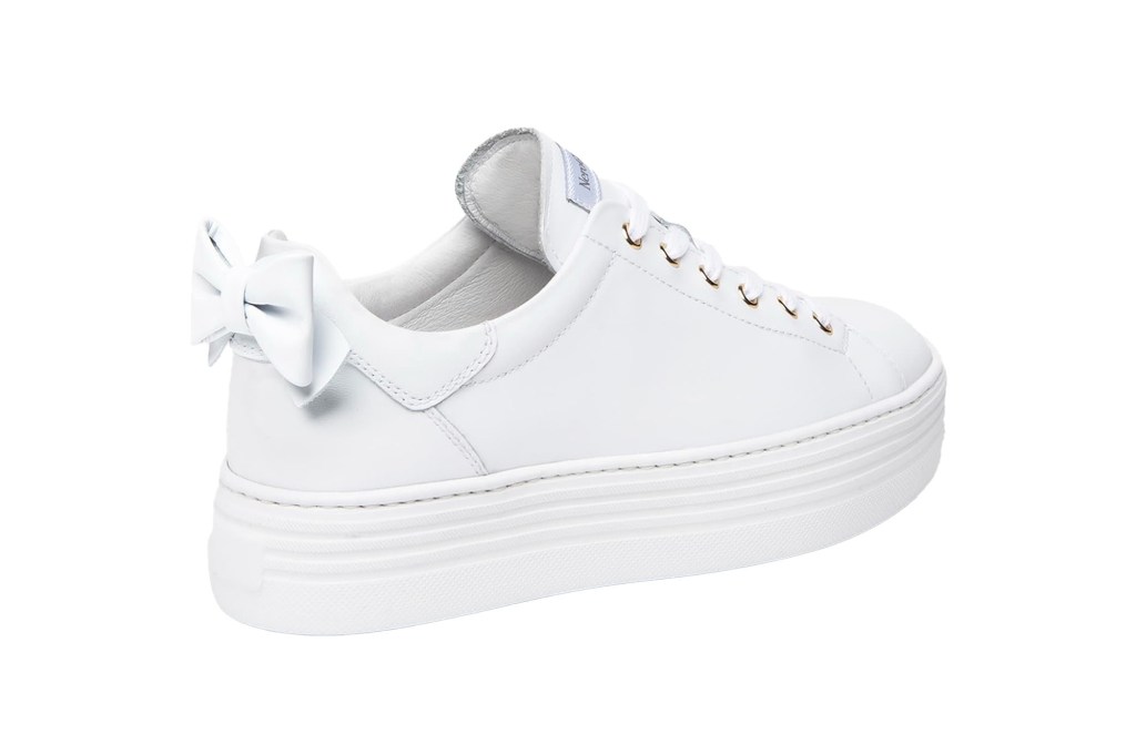 A white shoe with a bow on it.