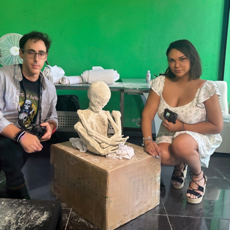 Filmmakers Michael Mazzola and Serena DC pose with a mummified creature found in Peru.