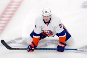 Scott Mayfield, New York Islanders defenseman, kneeling on ice for warm-up before playing against Pittsburgh Penguins at PPG Paints Arena.