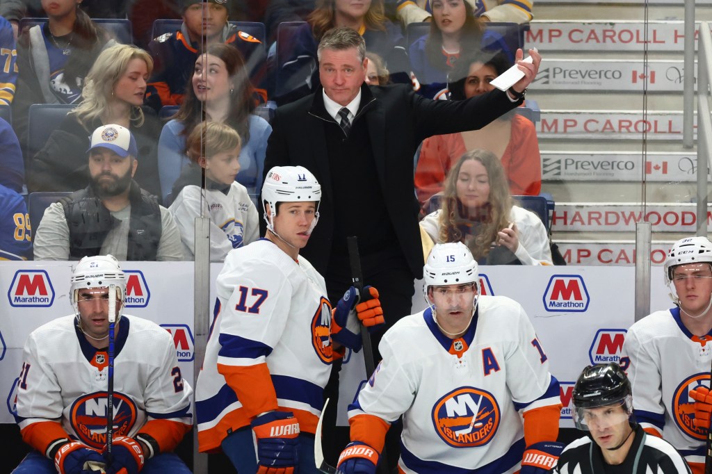 
Patrick Roy motions to pull the goalie during the third period of an NHL hockey game against the Buffalo Sabres.
