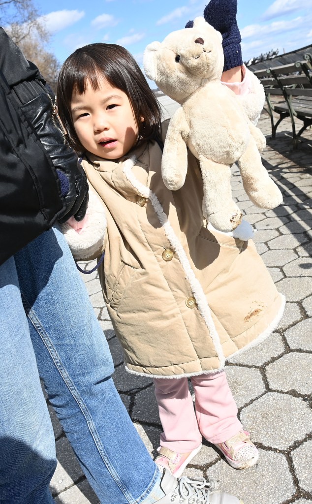 A photo of little 3-year-old Kyung Ha, who had her coat and teddy bear soiled  by pigeon poop while playing in the park.