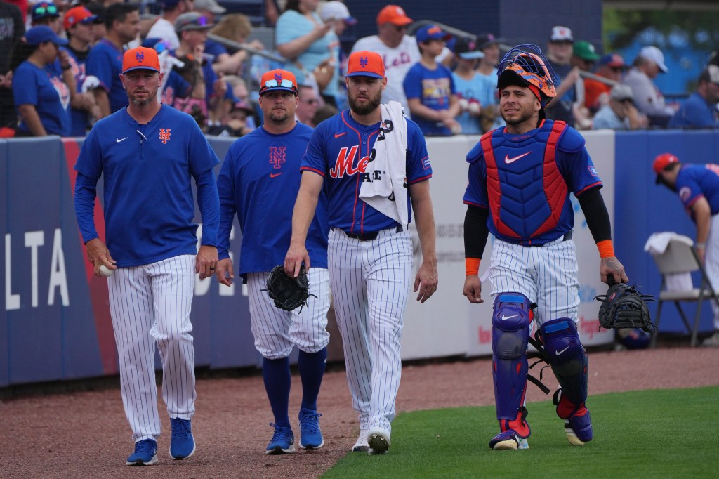 Mets relief pitcher Adrian Houser, center, and catcher Francisco Alvarez, right, enter from the bullpen before the game against the Detroit Tigers at Clover Park.