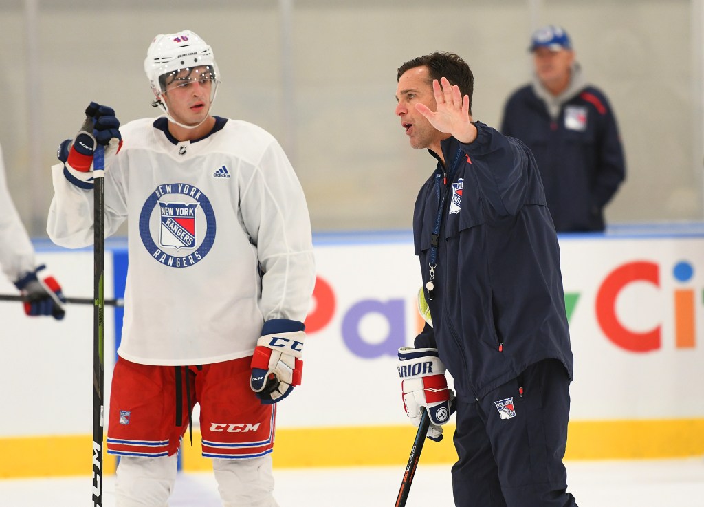 Crawley, on the ice with his stick and in white practice uniform with red shorts during a practice