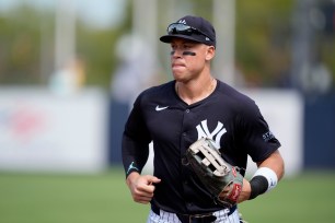 Aaron Judge running to the dugout during a baseball game between the New York Yankees and Tampa Bay Rays.