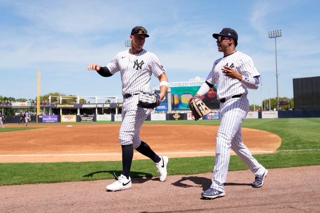 Yankees center fielder Aaron Judge, left, walks to the dugout with teammate right fielder Juan Soto.