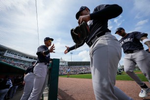 New York Yankees players George Lombardi, Jr. and Jahmai Jones enter the dugout before a game against the Minnesota Twins.