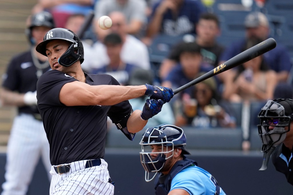 Giancarlo Stanton of the New York Yankees hitting a foul ball during a spring training game against the Tampa Bay Rays