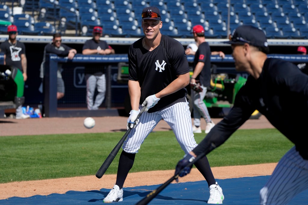 Yankees right fielder Aaron Judge fields the ball during batting practice before a spring training baseball game