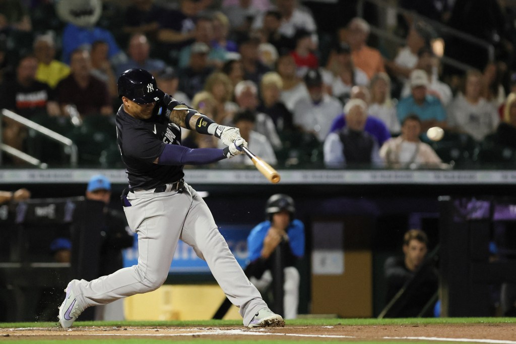 Gleyber Torres (25) hits a single against the Miami Marlins during the first inning at Roger Dean Chevrolet Stadium.