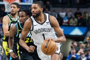 Mikal Bridges, who had just seven points, drives on Aaron Nesmith during the Nets' 121-100 loss to the Pacers.