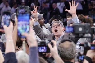 Dan Hurley celebrates after UConn's 73-57 Big East Tournament-clinching victory over Marquette.