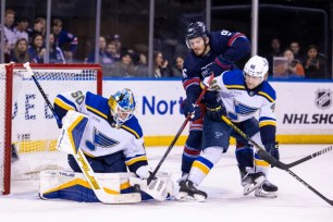 New Ranger Jack Roslovic looks to poke the puck in the net as Blues goalie Jordan Binnington defends during the Blueshirts' 4-0 win.