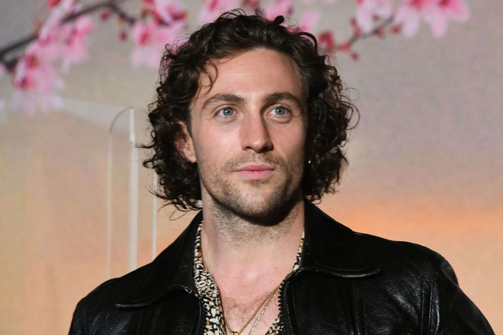 Aaron Taylor-Johnson wearing a black leather jacket.