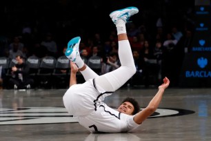 Cam Johnson falls to the ground after getting fouled by Kyle Lowry during the Nets' 112-107 win over the 76ers. Johnson sprained his right ankle and was forced to exit the game soon after the play.