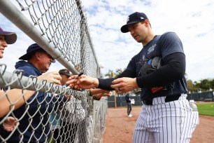 Yankees reliever Tommy Kahnle signs autographs for fans earlier in spring training.