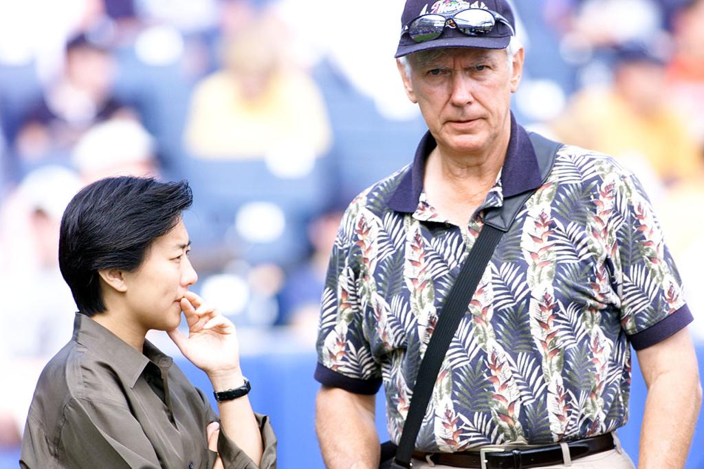 Yankee Assistant GM Kim Ng talking with Gene Michaels on the field during practice at Legends Field in Tampa, Florida.