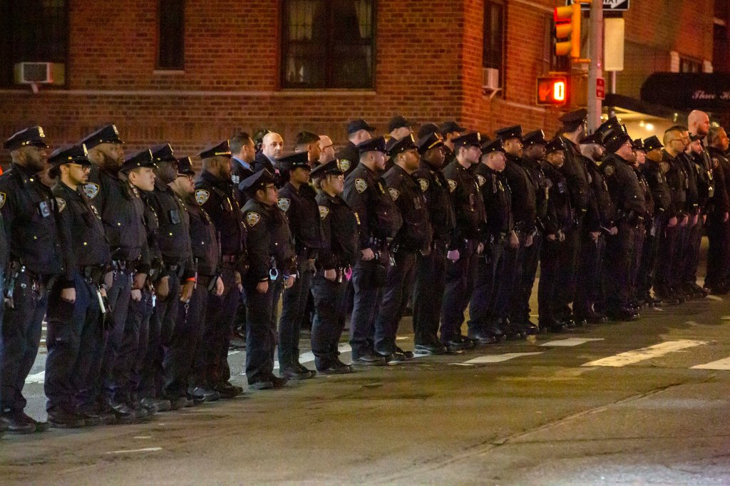 NYPD lines up andf the City Morgue in Manhattan to honor fellow office Jonathan Diller, 31, who was shot dead during a traffic stop in Queens.