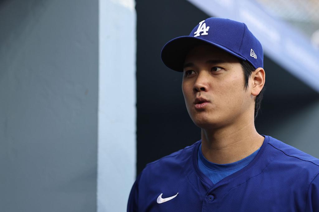 Shohei Ohtani #17 of the Los Angeles Dodgers walks into the dugout prior to a game against the Los Angeles Angels at Dodger Stadium on March 25, 2024 in Los Angeles, California. 