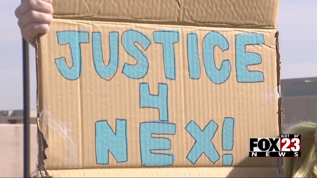 A "Justice 4 Nex" sign is hung up outside during a walkout in by Owasso students to honor Nex Benedict. 