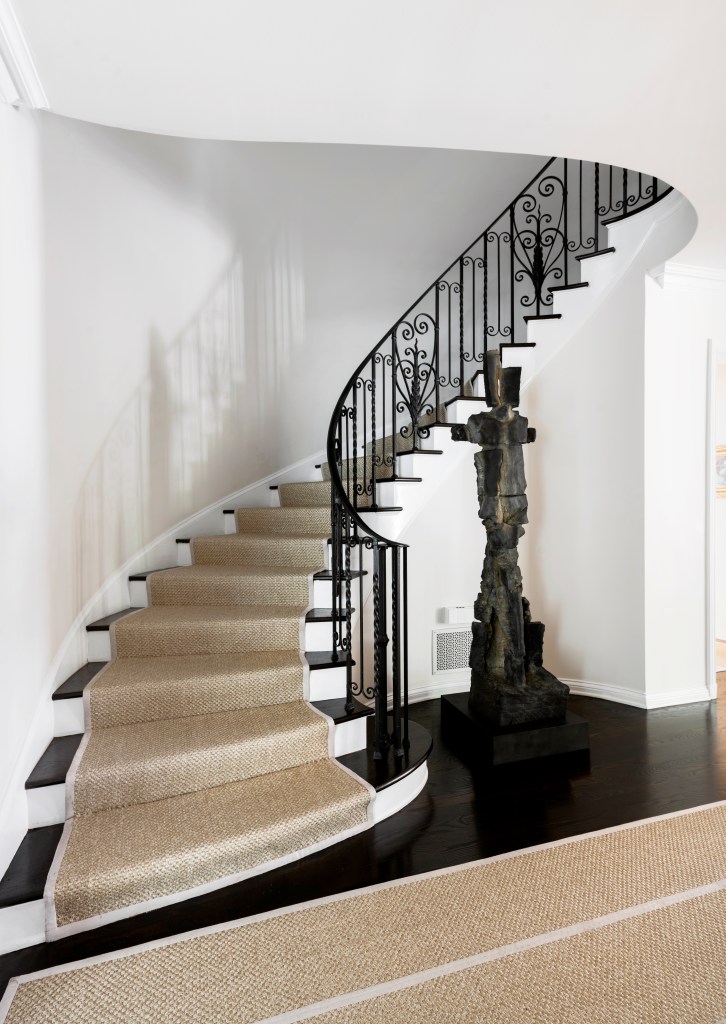 A wrought-iron banister anchors the entry.