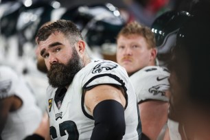 Jason Kelce, Philadelphia Eagles center, on the sideline in white uniform during the 2024 NFC wild card game against Tampa Bay Buccaneers.