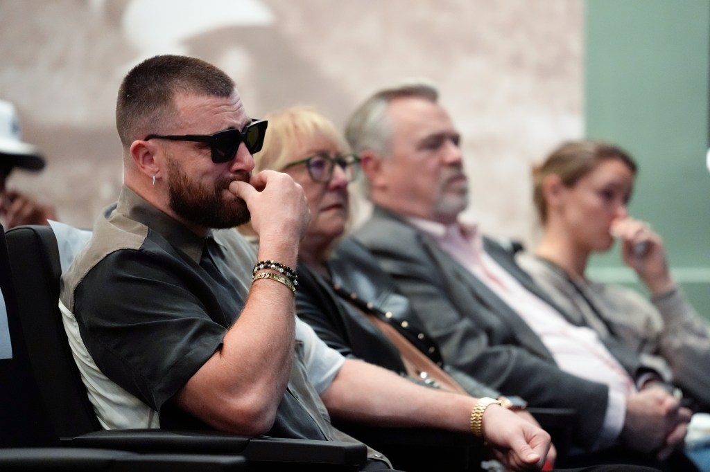 Kelce's family, from left, Kansas City Chiefs' Travis Kelce, mother, Donna Kelce, father, Ed Kelce, and wife, Kylie McDevitt Kelce, listens as Jason Kelce announces his retirement