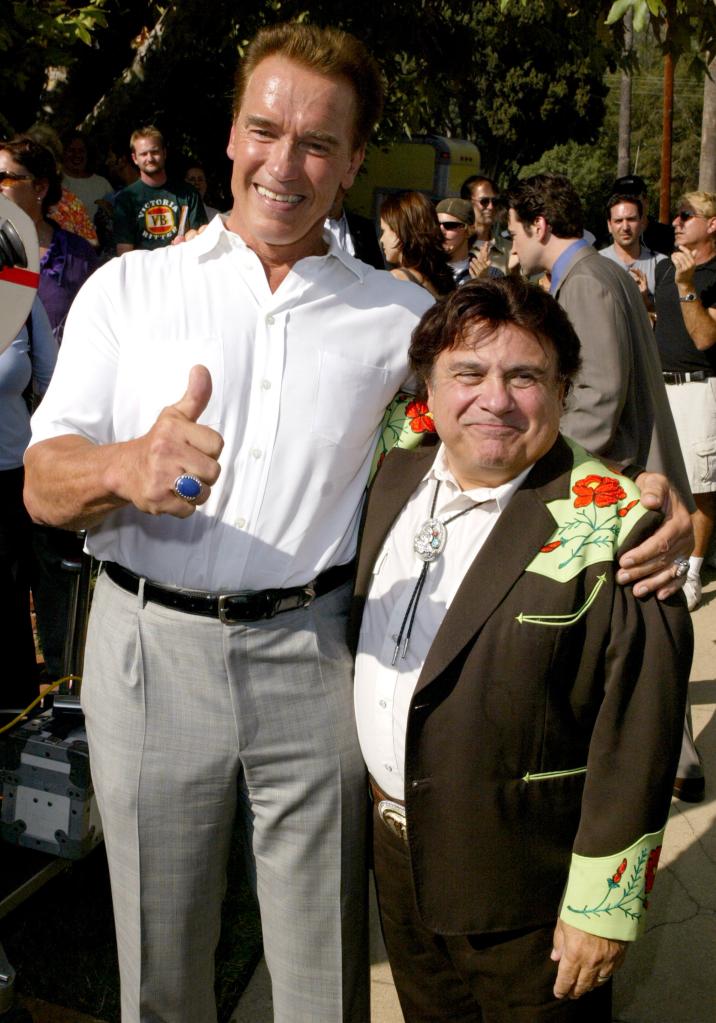 Arnold Schwarzenegger and Danny DeVito smiling  together. 