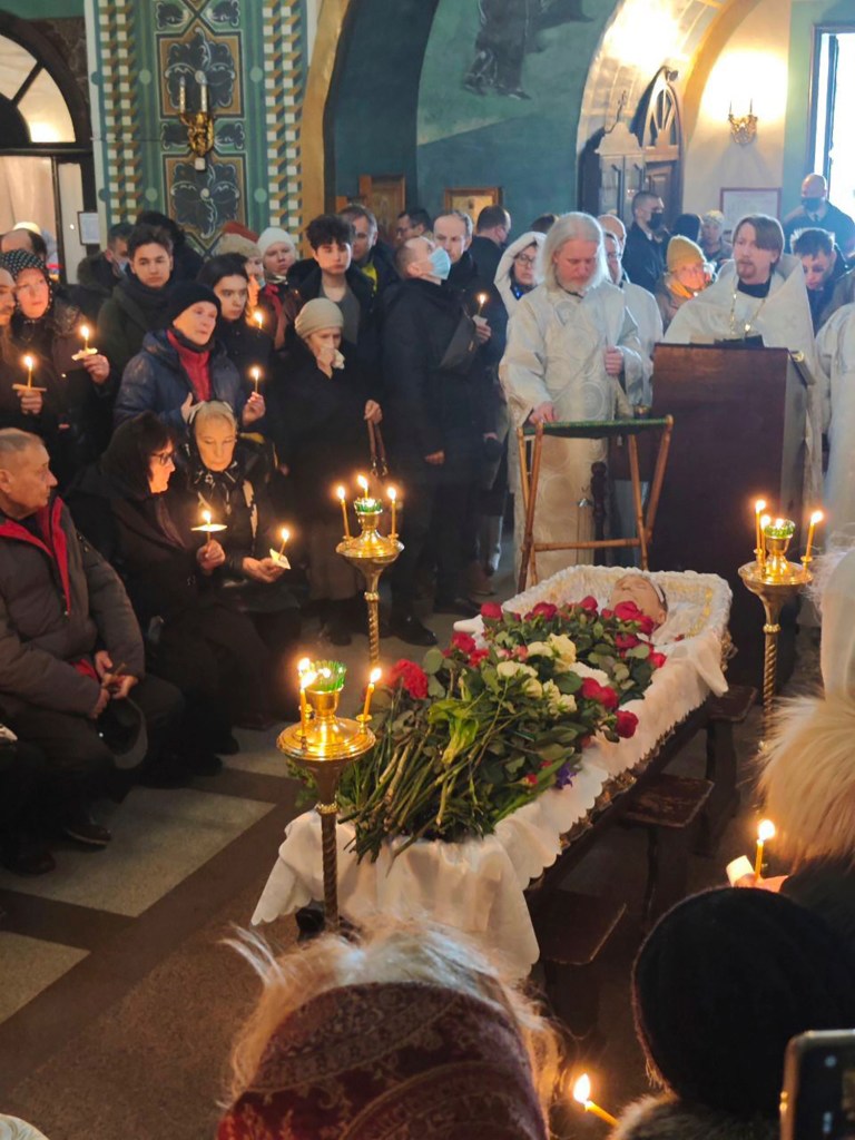 Somber photos taken inside the church showed the politician’s body resting in a coffin covered in red and white roses, with candles burning around him.